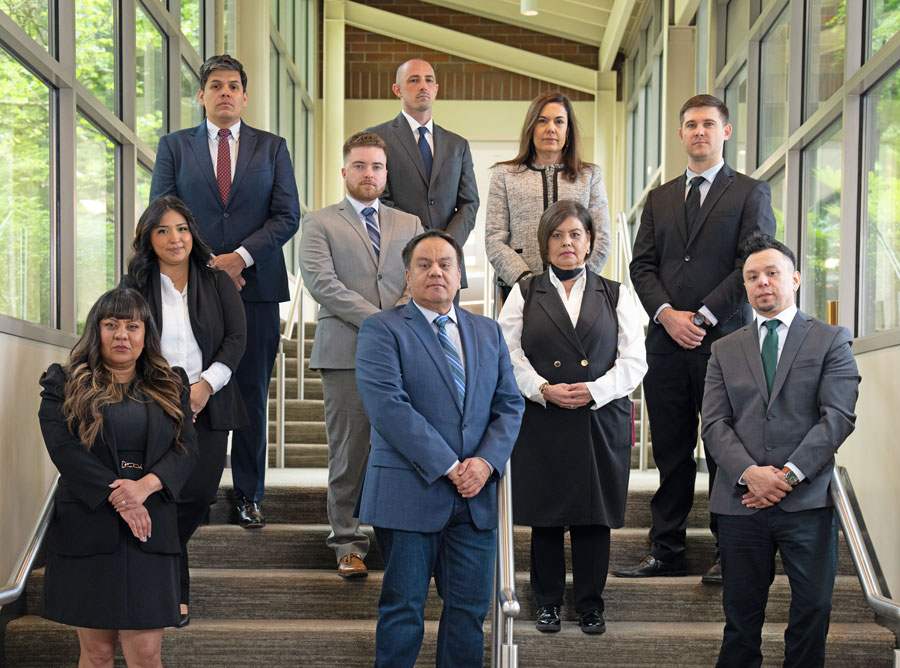 Professional team of attorneys and legal staff from Arellano Law Firm posing on a staircase inside Lincoln Tower, reflecting experience, unity, and dedication to client success.